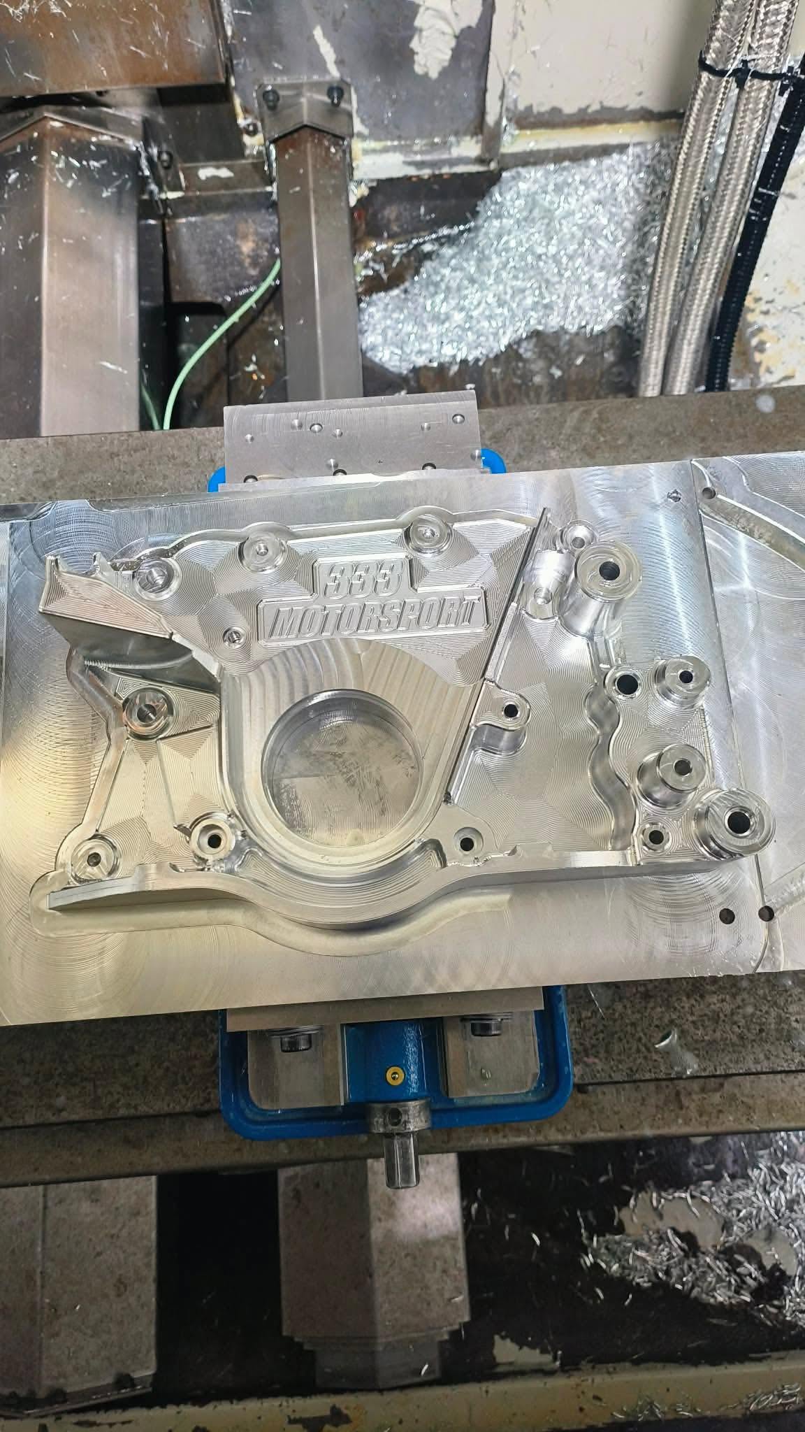 Billet aluminium part clamped on the CNC mill bed